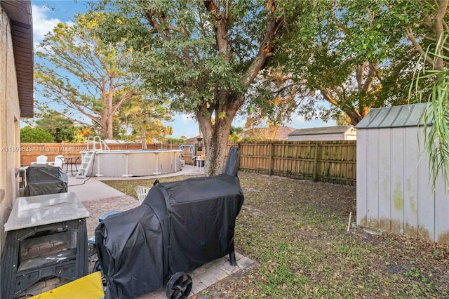 view of yard with a fenced in pool and a patio area