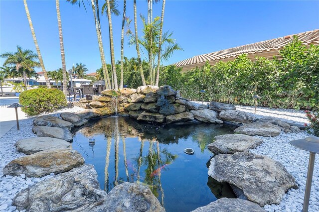 view of pool featuring a small pond