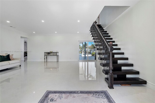 foyer entrance featuring crown molding