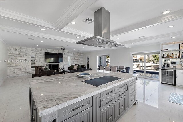 dining space featuring indoor bar, wine cooler, ornamental molding, light tile patterned flooring, and beam ceiling