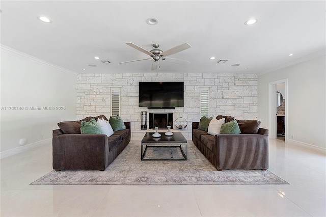 living room featuring ceiling fan, light tile patterned floors, a stone fireplace, and crown molding