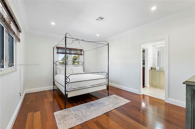 bedroom featuring wood-type flooring, ensuite bathroom, and crown molding