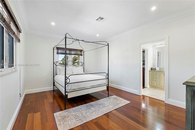 bedroom with dark wood-type flooring and ornamental molding