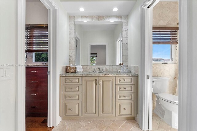 bathroom with toilet, vanity, and a shower with shower curtain