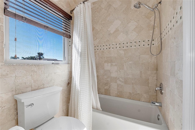 bathroom featuring toilet, tile walls, and shower / bath combo