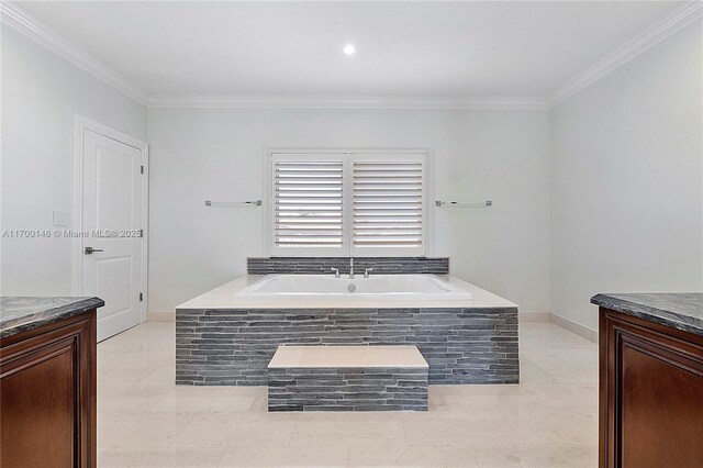 bathroom with tiled bath, vanity, and crown molding