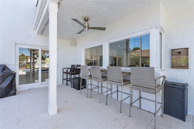 view of patio featuring ceiling fan