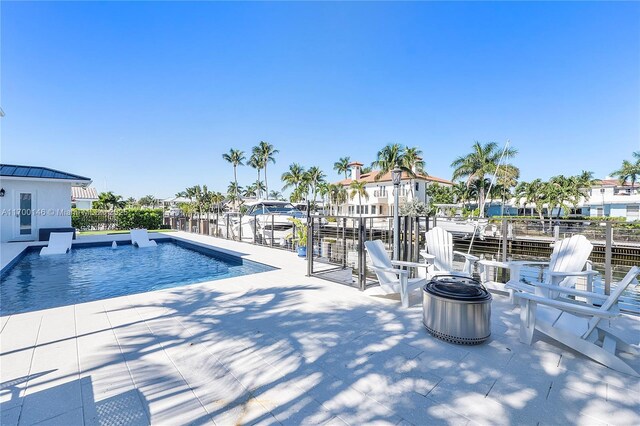 view of patio / terrace with a boat dock and a water view