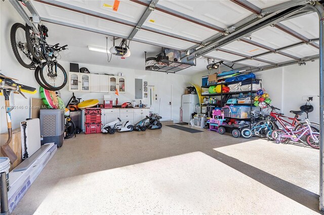 garage featuring a garage door opener and electric panel