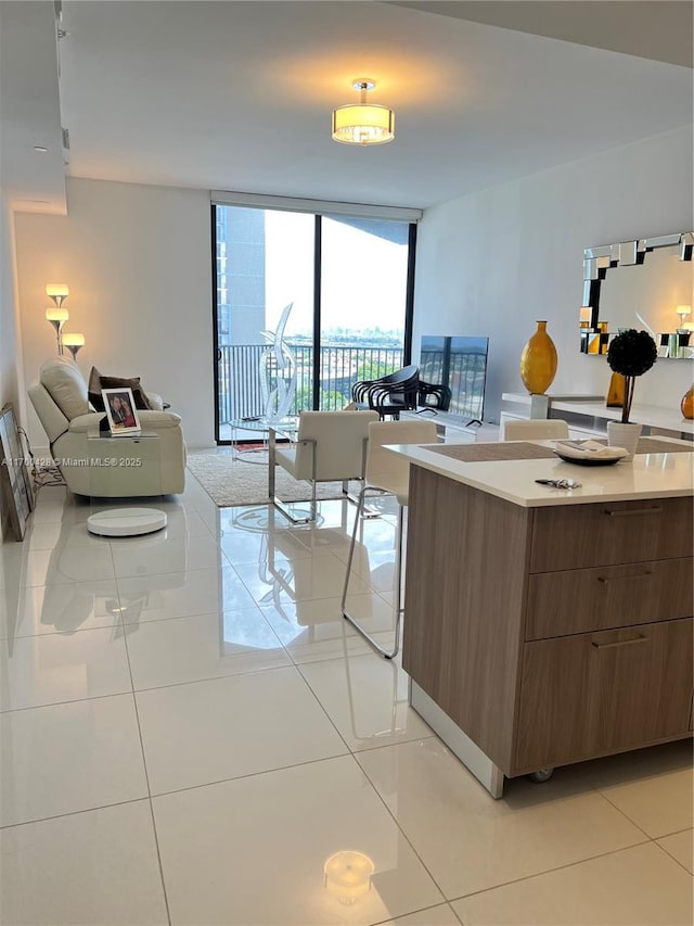 kitchen featuring a wall of windows and light tile patterned floors