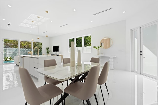 dining room with plenty of natural light, light tile patterned floors, and sink