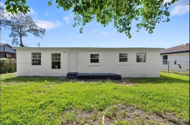 back of house featuring a yard