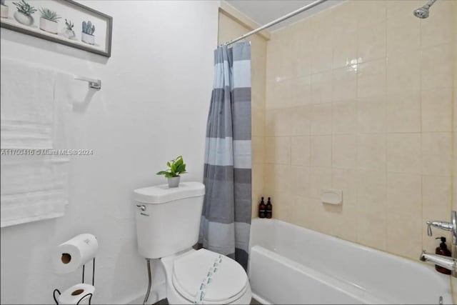 bathroom with toilet and shower / bathtub combination with curtain