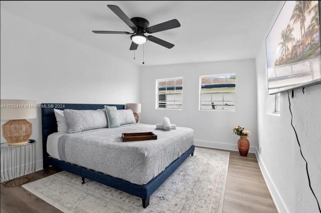 bedroom with hardwood / wood-style flooring and ceiling fan