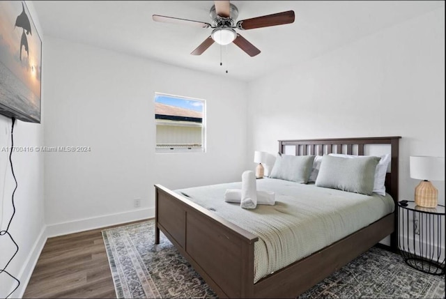 bedroom with ceiling fan and dark hardwood / wood-style floors