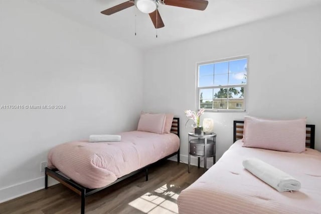 bedroom with ceiling fan and dark wood-type flooring