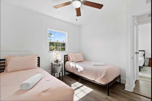 bedroom featuring ceiling fan and dark wood-type flooring