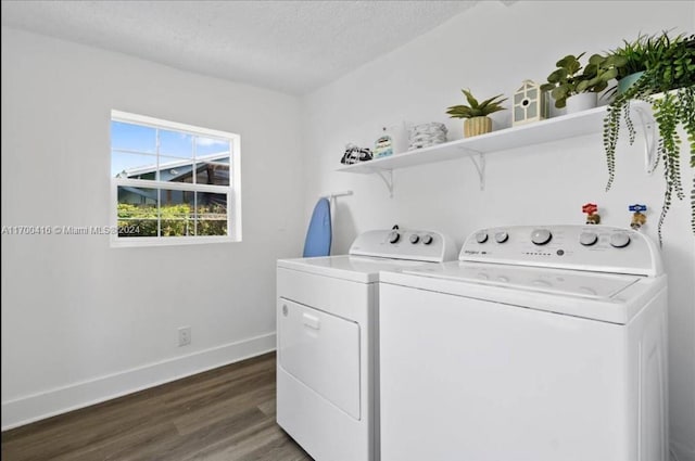 laundry area featuring washer and dryer, dark hardwood / wood-style flooring, and a textured ceiling