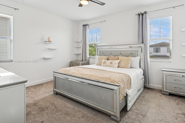 bedroom with ceiling fan and light colored carpet