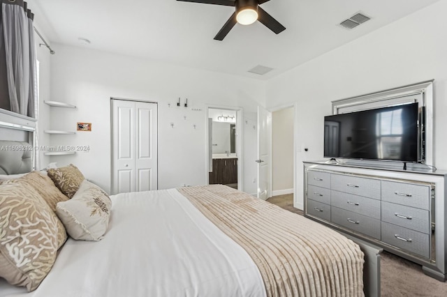 carpeted bedroom featuring connected bathroom, a closet, and ceiling fan