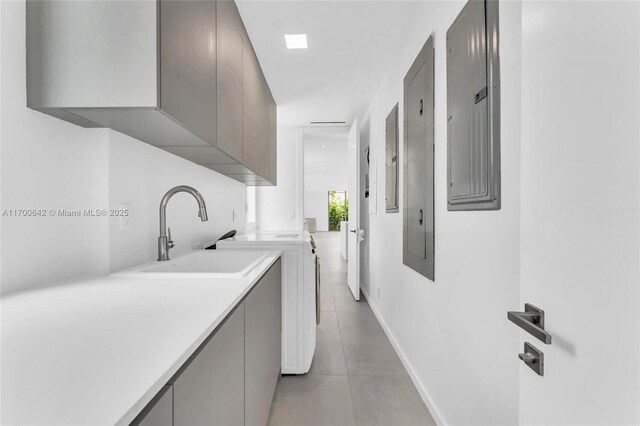 2110 S Miami Ave, Miami, FL 33129 - washroom with light tile patterned floors, a sink, electric panel, baseboards, and cabinet space