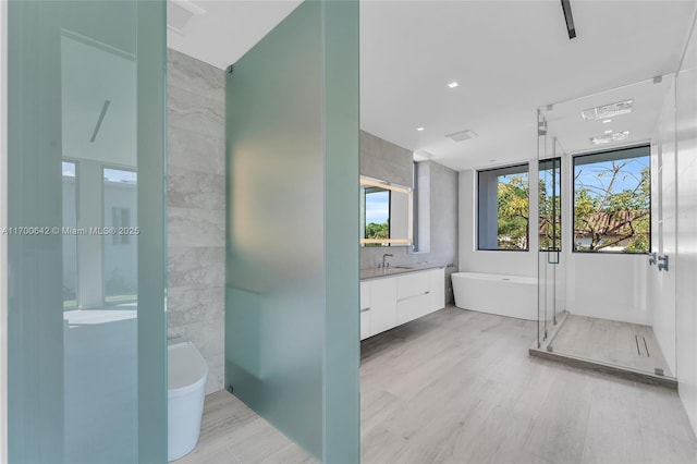 2110 S Miami Ave, Miami, FL 33129 - bathroom with a shower stall, a freestanding tub, wood finished floors, and vanity