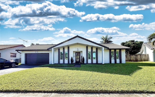 view of front of house featuring a front yard and a garage