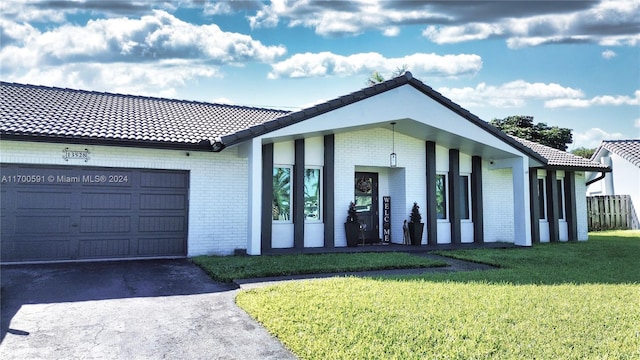 ranch-style home with a front yard and a garage