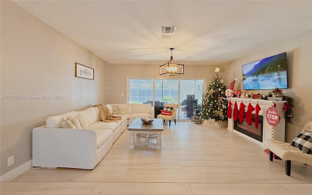 living room featuring a notable chandelier and light hardwood / wood-style flooring