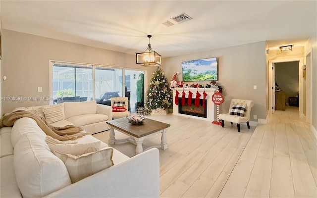 living room with hardwood / wood-style floors and a notable chandelier