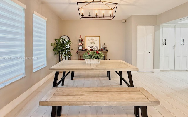 office space with a notable chandelier and light wood-type flooring