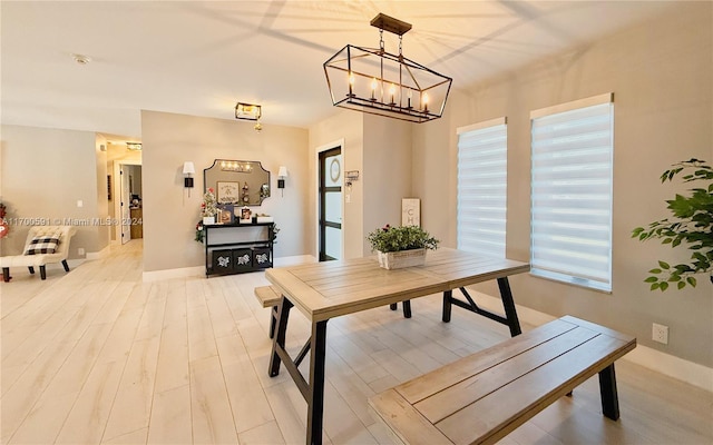 dining space with a notable chandelier and wood-type flooring