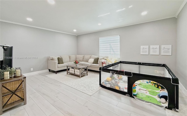 living room with light hardwood / wood-style floors and ornamental molding