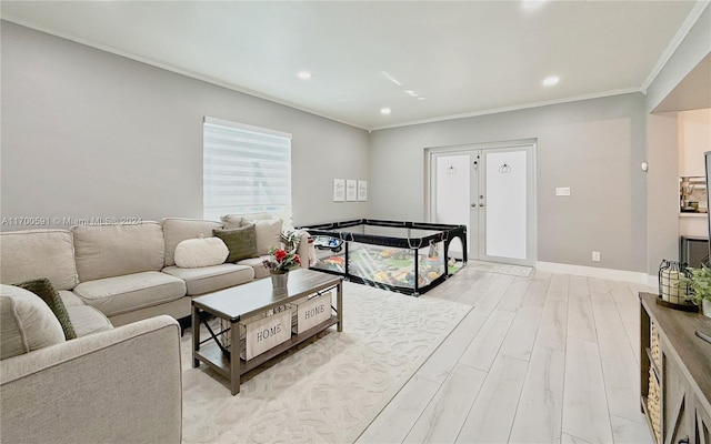 living room featuring crown molding and light hardwood / wood-style flooring