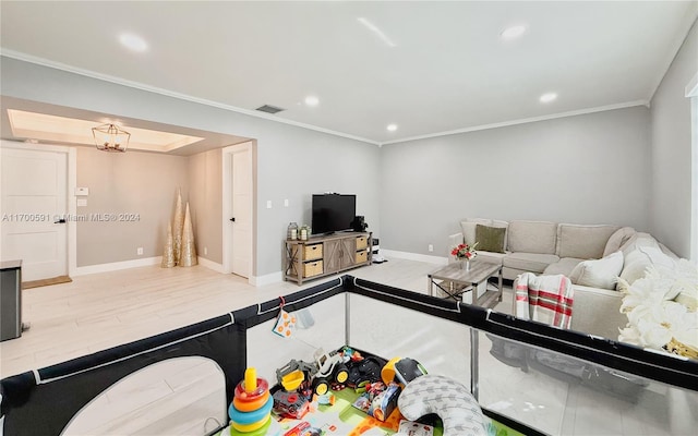 living room with light hardwood / wood-style flooring and ornamental molding