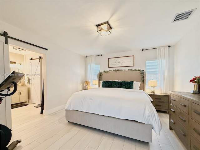 bedroom featuring light hardwood / wood-style floors and multiple windows