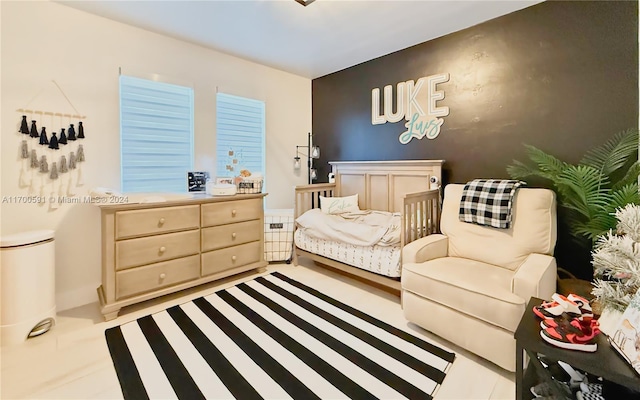 living area featuring radiator and light tile patterned flooring