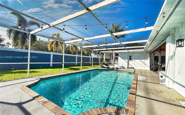 view of swimming pool featuring glass enclosure and a patio