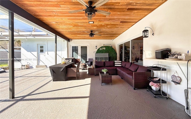 view of patio featuring outdoor lounge area, french doors, and ceiling fan