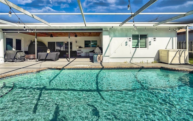 view of swimming pool with ceiling fan and a patio area