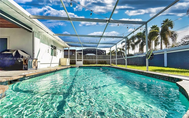 view of swimming pool with a lanai