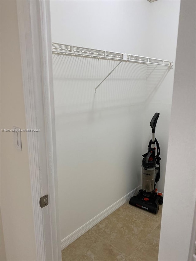 walk in closet with tile patterned flooring