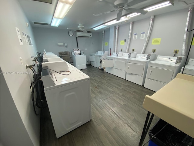 clothes washing area featuring separate washer and dryer, ceiling fan, a wall mounted air conditioner, and dark hardwood / wood-style floors