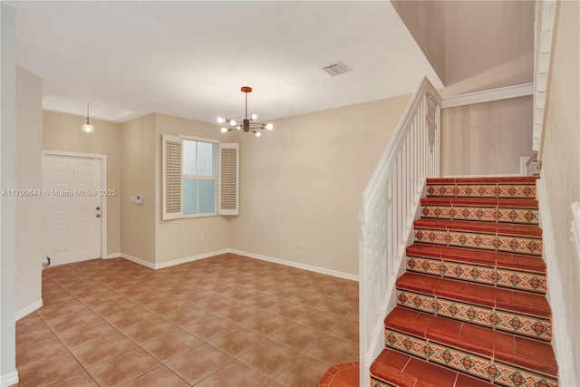 staircase featuring tile patterned flooring and a chandelier