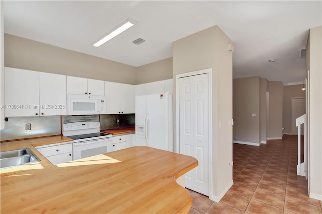 12564 SW 121st Way, Miami, FL 33186 - kitchen with white appliances, light tile patterned floors, tasteful backsplash, a sink, and baseboards
