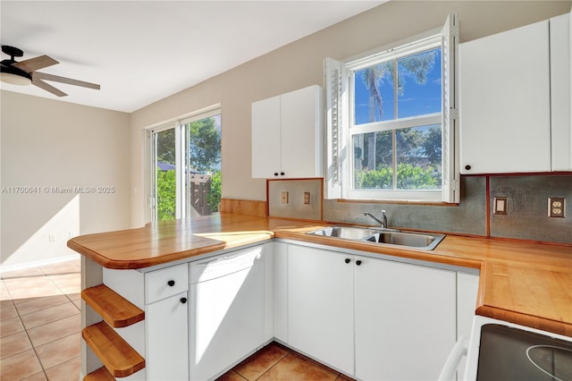 12564 SW 121st Way, Miami, FL 33186 - kitchen featuring white appliances, a sink, a peninsula, light tile patterned flooring, and white cabinetry