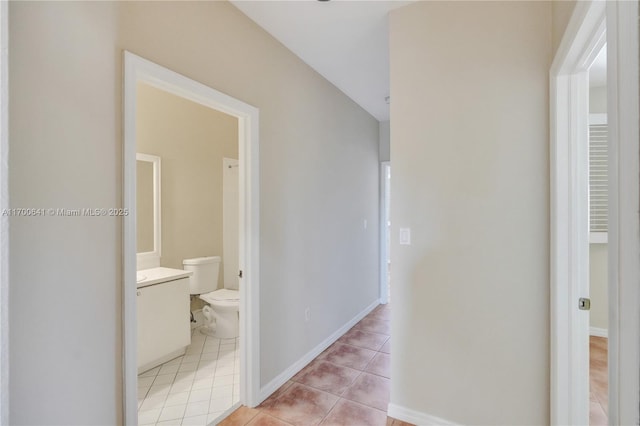 corridor featuring light tile patterned flooring