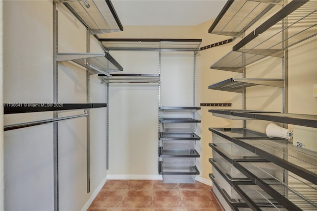 walk in closet featuring light tile patterned flooring