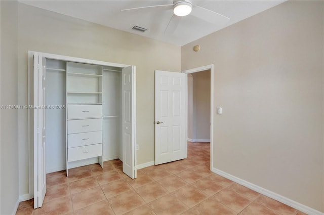 unfurnished bedroom featuring ceiling fan, a closet, and light tile patterned floors