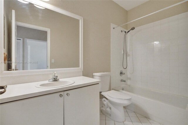 full bathroom with tile patterned floors, vanity, toilet, and tiled shower / bath combo